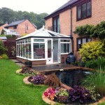 An image of a white uPVC conservatory with black cast on detail