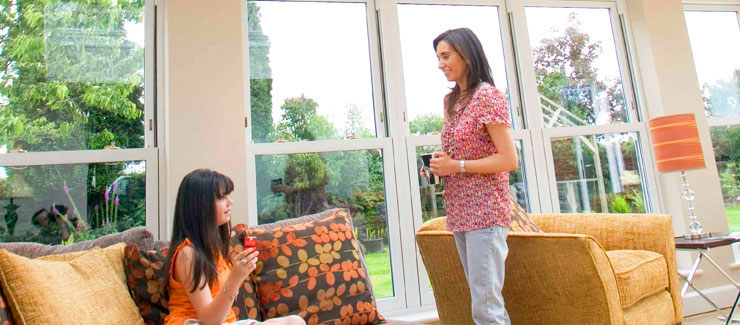A bright conservatory with nice decor and family enjoying the space