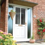 A white front door with hanging basket