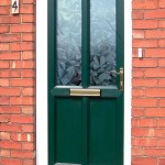 A green uPVC door with patterned glass