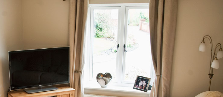 A sitting room with residence 9 timber effect windows