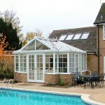 A T shape uPVC conservatory next to a pool