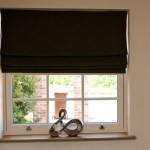 An internal view of a sash window with blind pulled halfway down