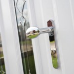 An image of a white uPVC door with chrome handle