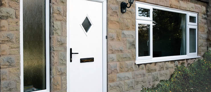 A white composite door with iron detail